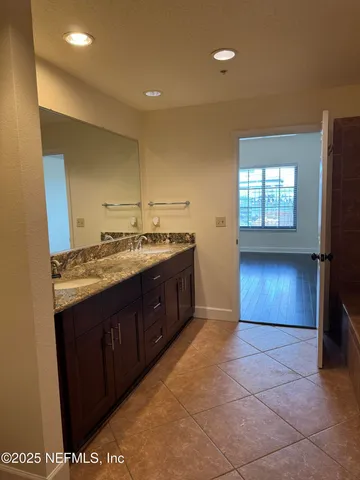 a bathroom with a sink vanity and a mirror