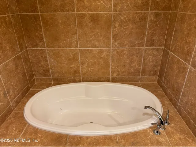 a bathroom with a bath tub