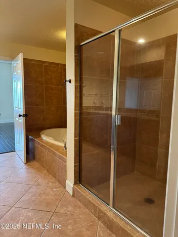 a bathroom with a bathtub and a shower