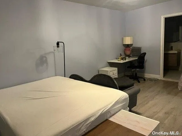 a bedroom with a bed and a lamp on table