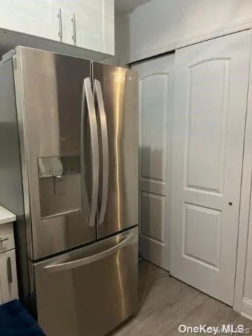 a metallic refrigerator freezer sitting in a kitchen
