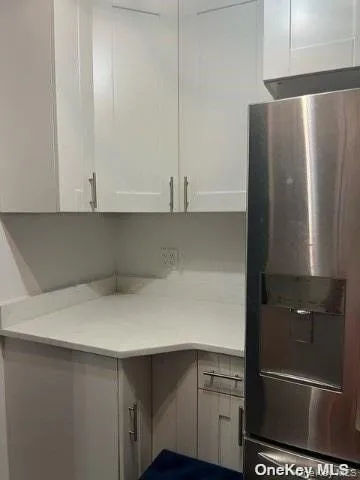 a view of cabinets and refrigerator