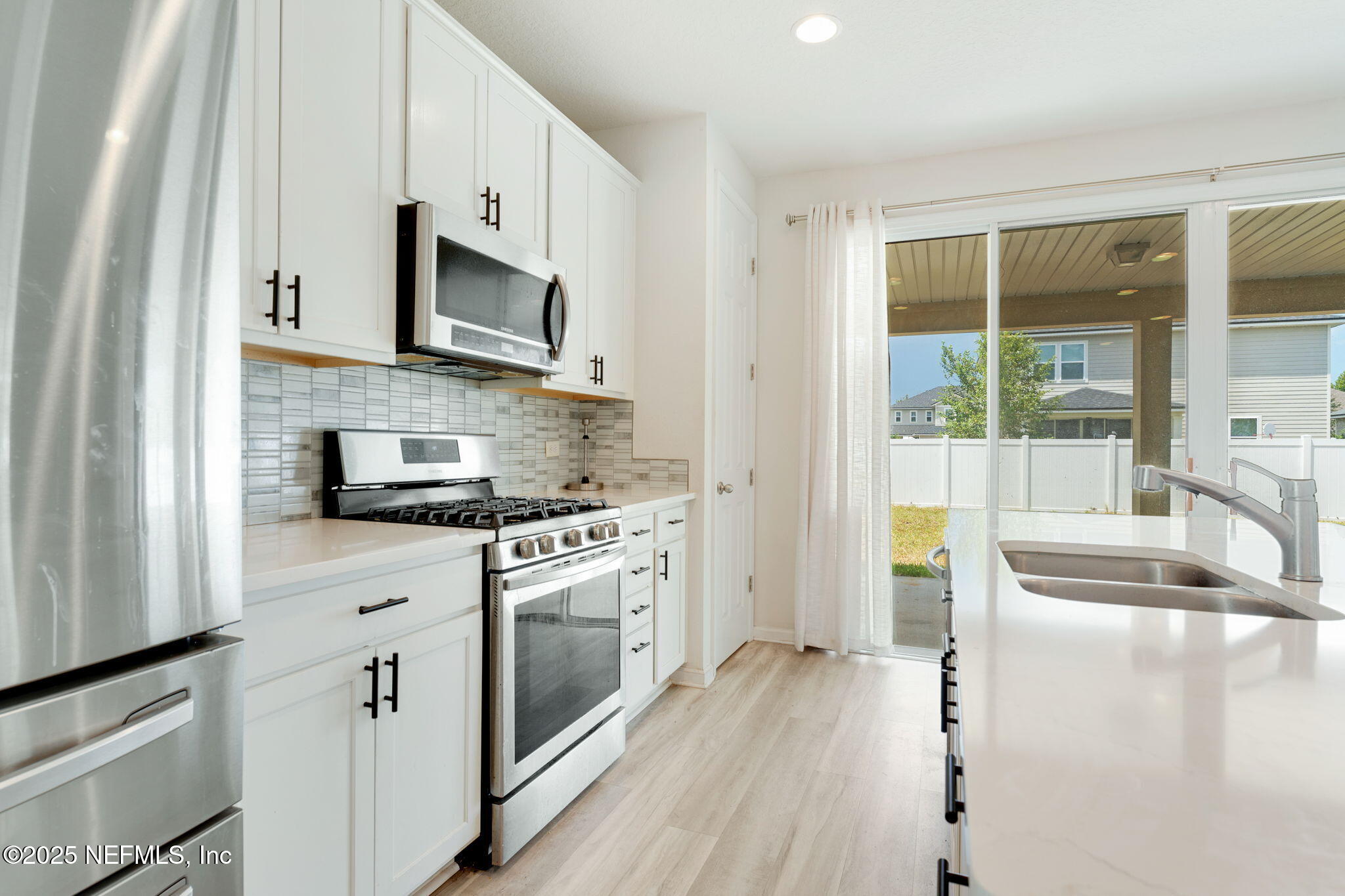 52 Opal Way St. Augustine, FL 32086 - Photo 17 of 55 a kitchen with stainless steel appliances granite countertop a stove a sink and a refrigerator