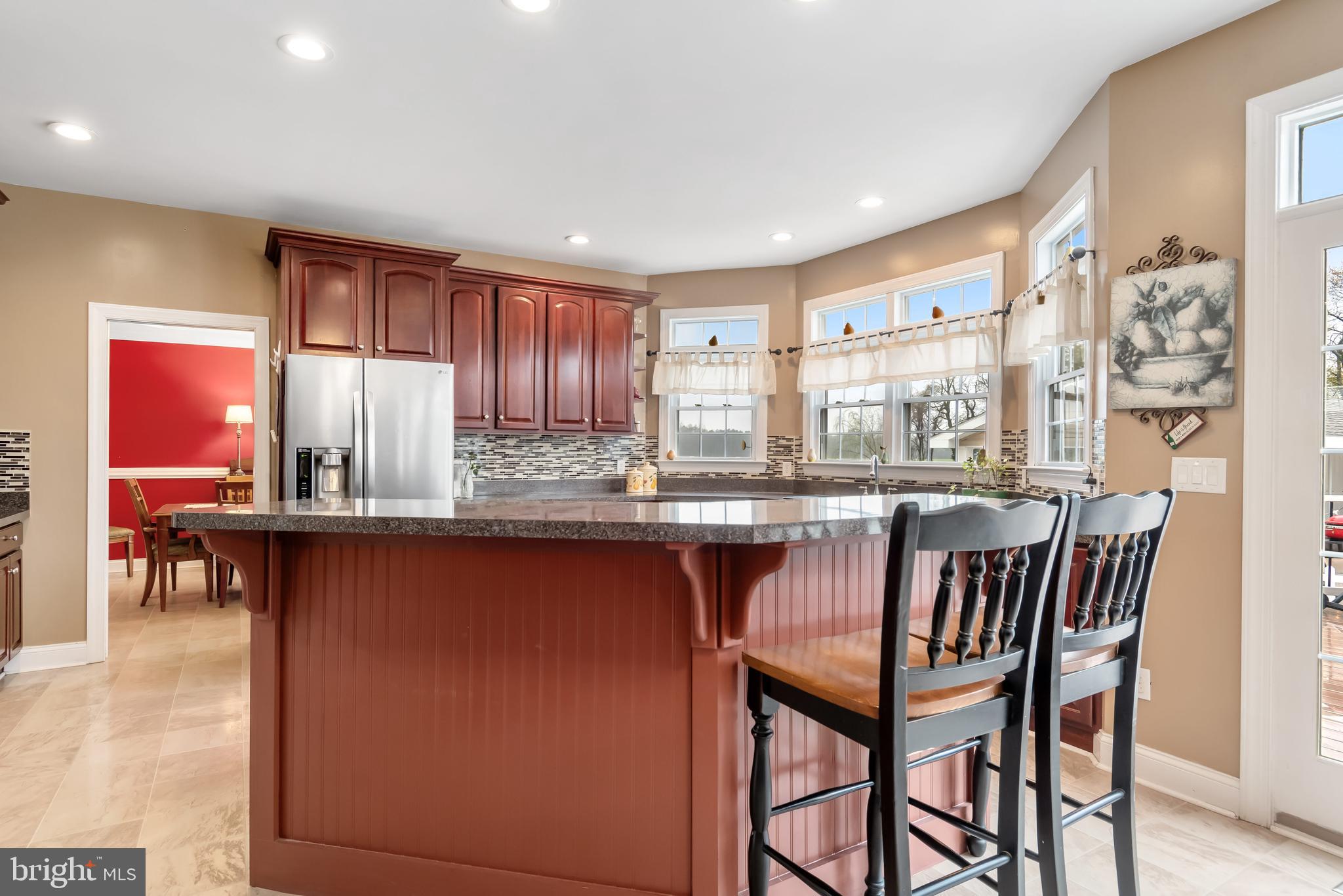 5855 Bethlehem Road Preston, MD 21655 - Photo 22 of 43 a dining hall with stainless steel appliances granite countertop a dining table and chairs with wooden floor
