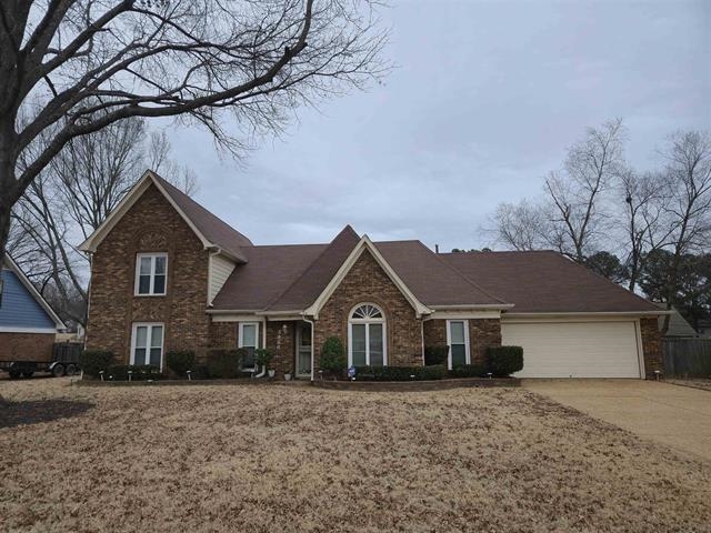 3950 Bobby Jones Road Memphis, TN 38125 - Photo 1 of 21 Traditional-style house featuring concrete driveway, brick siding, and a garage