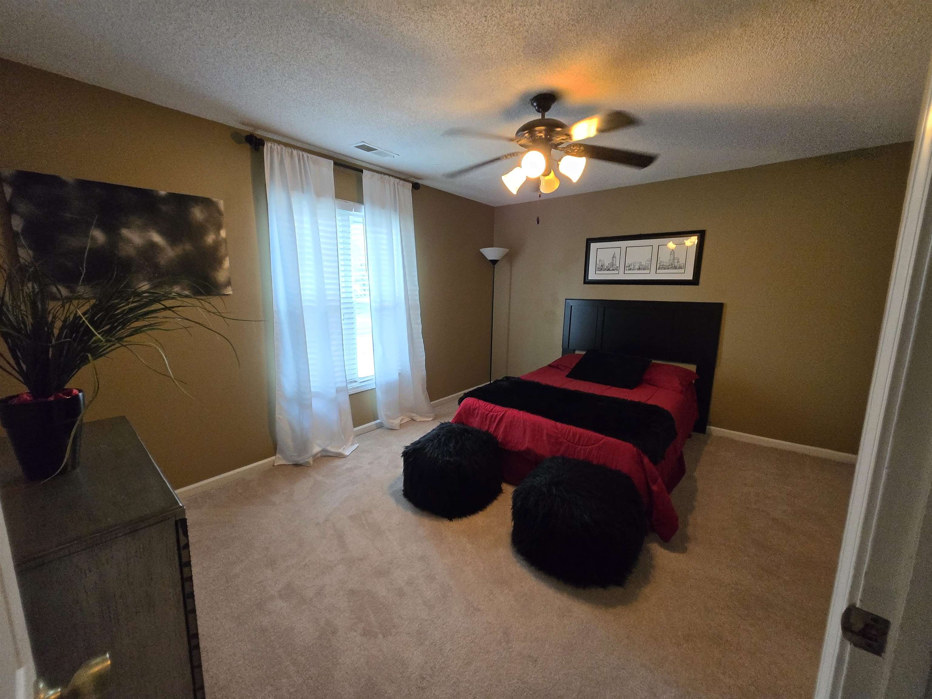 3950 Bobby Jones Road Memphis, TN 38125 - Photo 20 of 21 Carpeted bedroom featuring a textured ceiling, a ceiling fan, and baseboards
