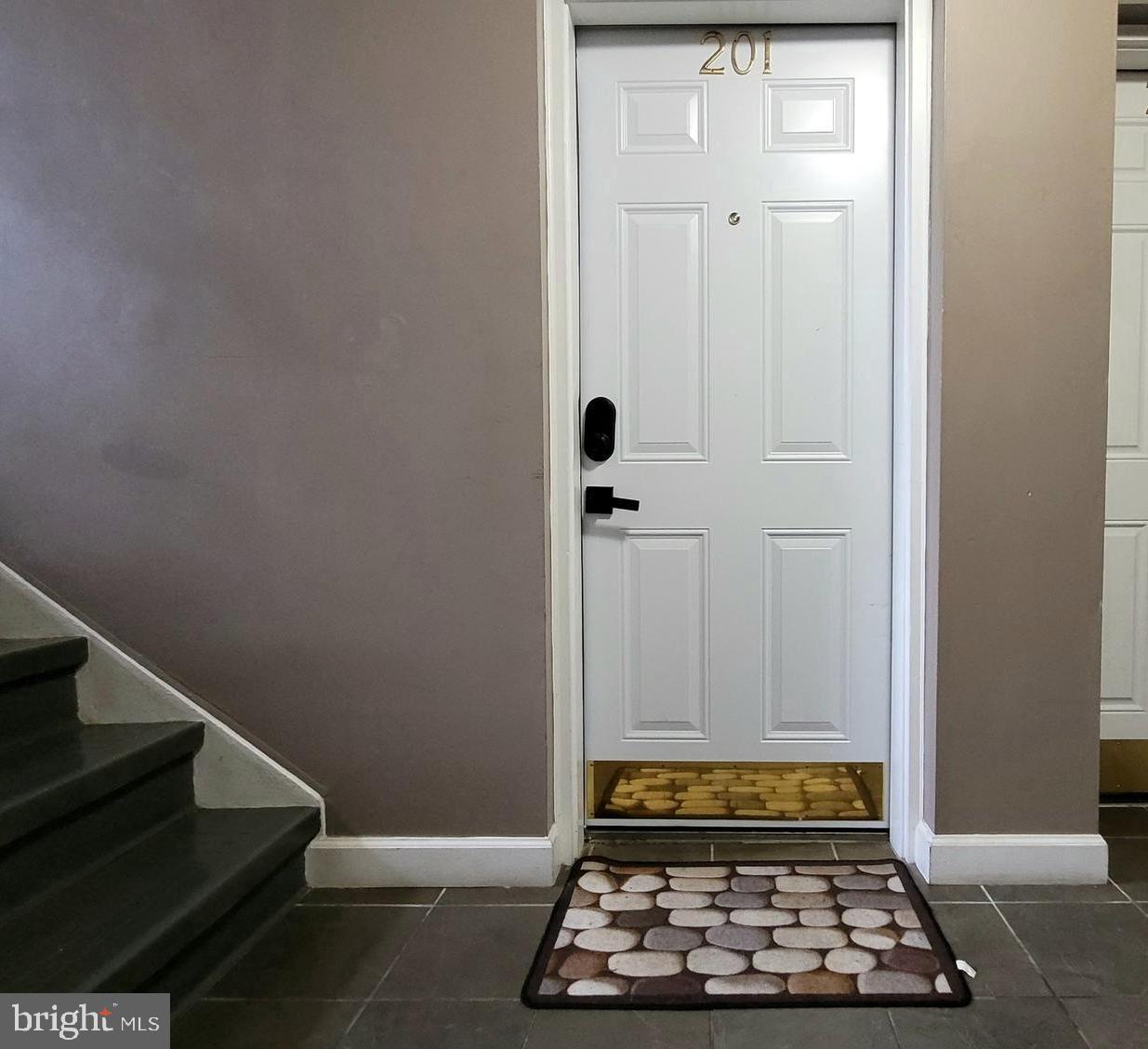 705 Brandywine Street Southeast, Unit 201 Washington, DC 20032 - Photo 12 of 15 a room with hard wood and a window