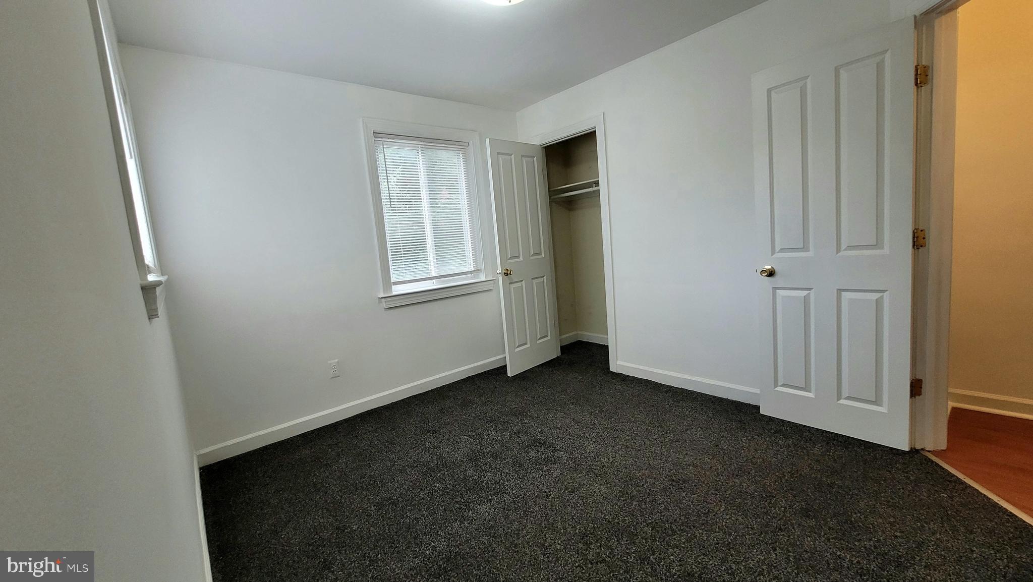 705 Brandywine Street Southeast, Unit 201 Washington, DC 20032 - Photo 8 of 15 an empty room with windows