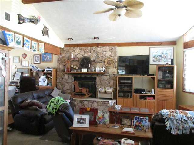 16325 Lyons Valley Road Jamul, CA 91935 - Photo 5 of 23 with cathedral ceiling, loads of light and rock fireplace with stone hearth