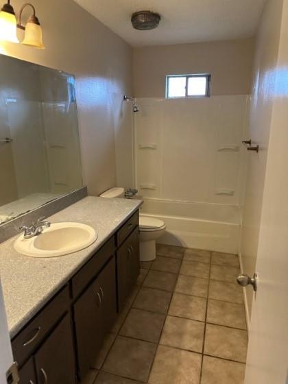 409 Skyline Circle Lorena, TX 76655 - Photo 10 of 16 a bathroom with a granite countertop sink a toilet and shower