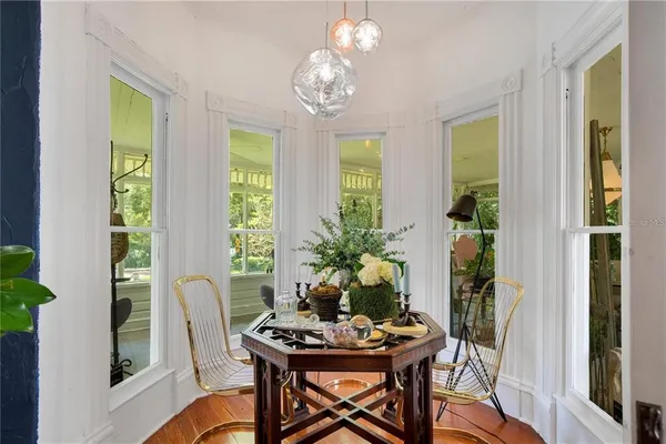 a living room with furniture and large windows