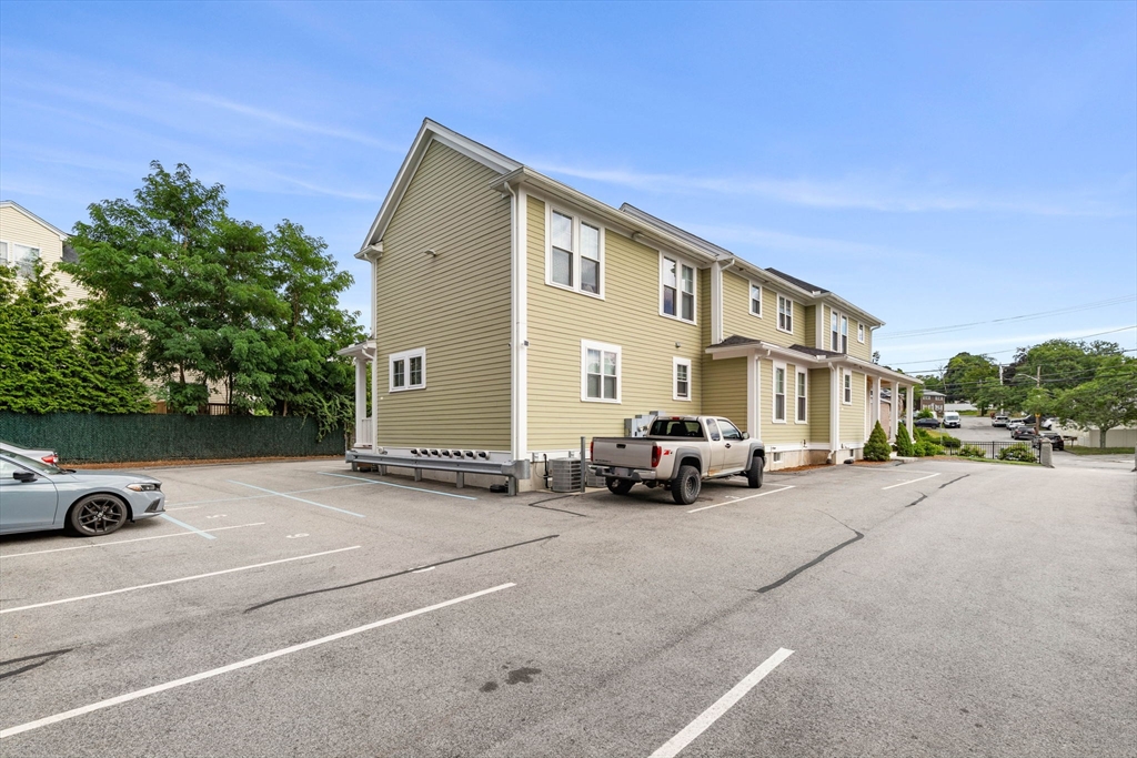 1149 Middlesex Street, Unit 4 Lowell, MA 01851 - Photo 2 of 6 a view of a street with cars