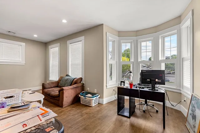 a living room with furniture and a floor to ceiling window