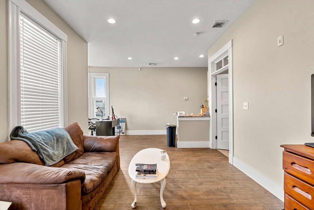 1149 Middlesex Street, Unit 4 Lowell, MA 01851 - Photo 5 of 6 a living room with furniture and a window