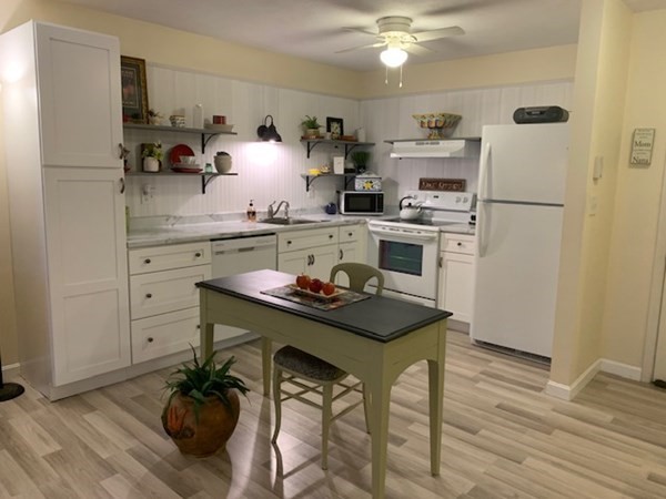 a kitchen with a table and appliances in it