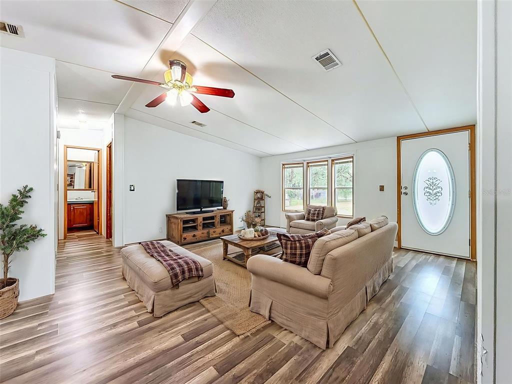1819 Sinclair Hills Road Lutz, FL 33549 - Photo 19 of 60 a living room with furniture a flat screen tv and a fireplace