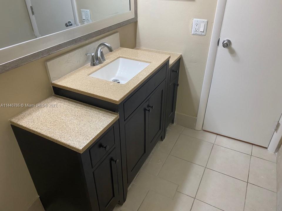 721 North Pine Island Road, Unit 304 Plantation, FL 33324 - Photo 11 of 22 a bathroom with a sink and a mirror