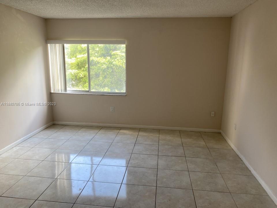 721 North Pine Island Road, Unit 304 Plantation, FL 33324 - Photo 13 of 22 an empty room with a window