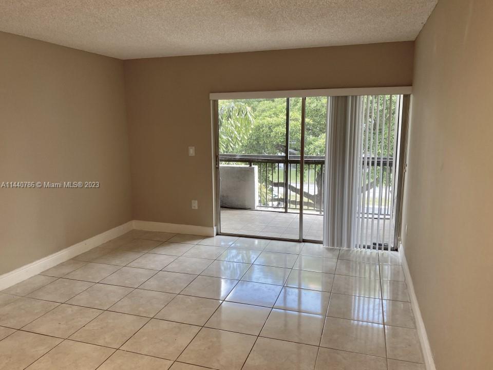 721 North Pine Island Road, Unit 304 Plantation, FL 33324 - Photo 15 of 22 a view of an empty room with glass door