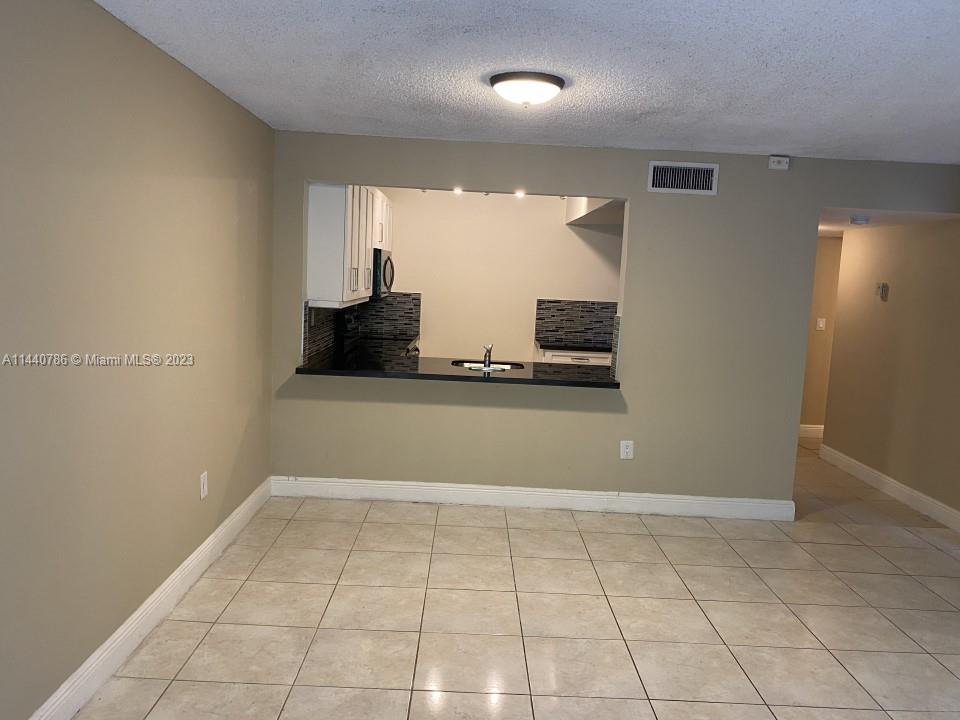 721 North Pine Island Road, Unit 304 Plantation, FL 33324 - Photo 6 of 22 a view of a refrigerator in the kitchen