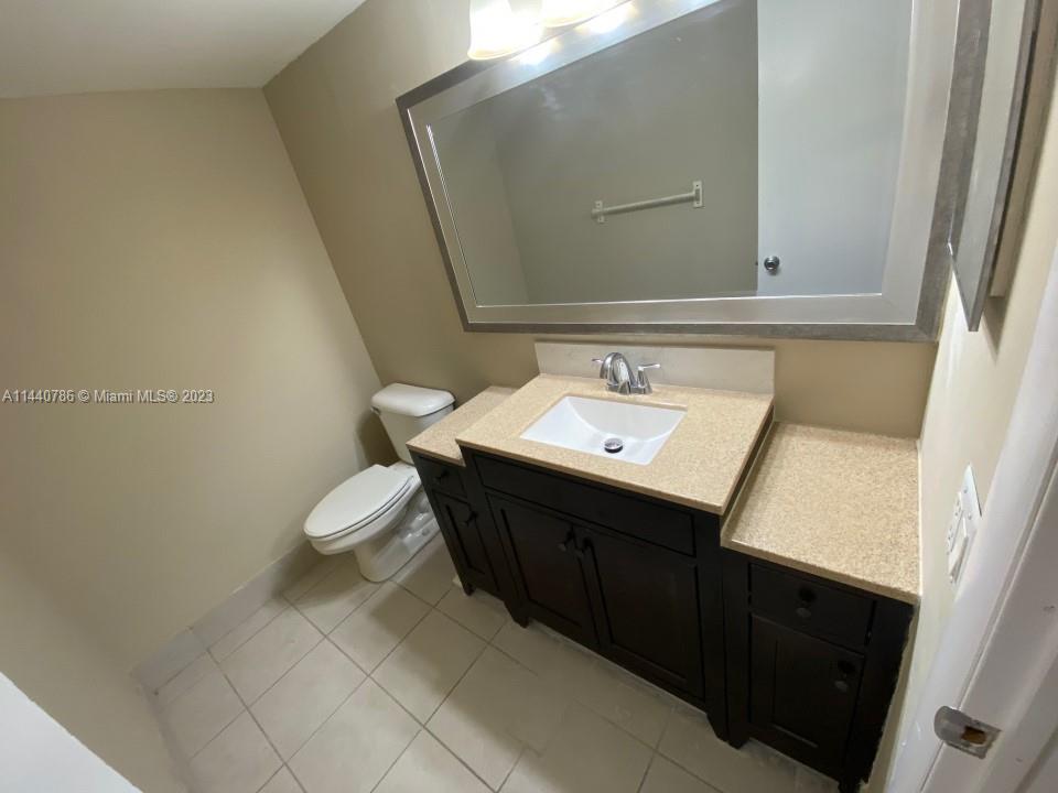 721 North Pine Island Road, Unit 304 Plantation, FL 33324 - Photo 10 of 22 a bathroom with a sink vanity and a toilet