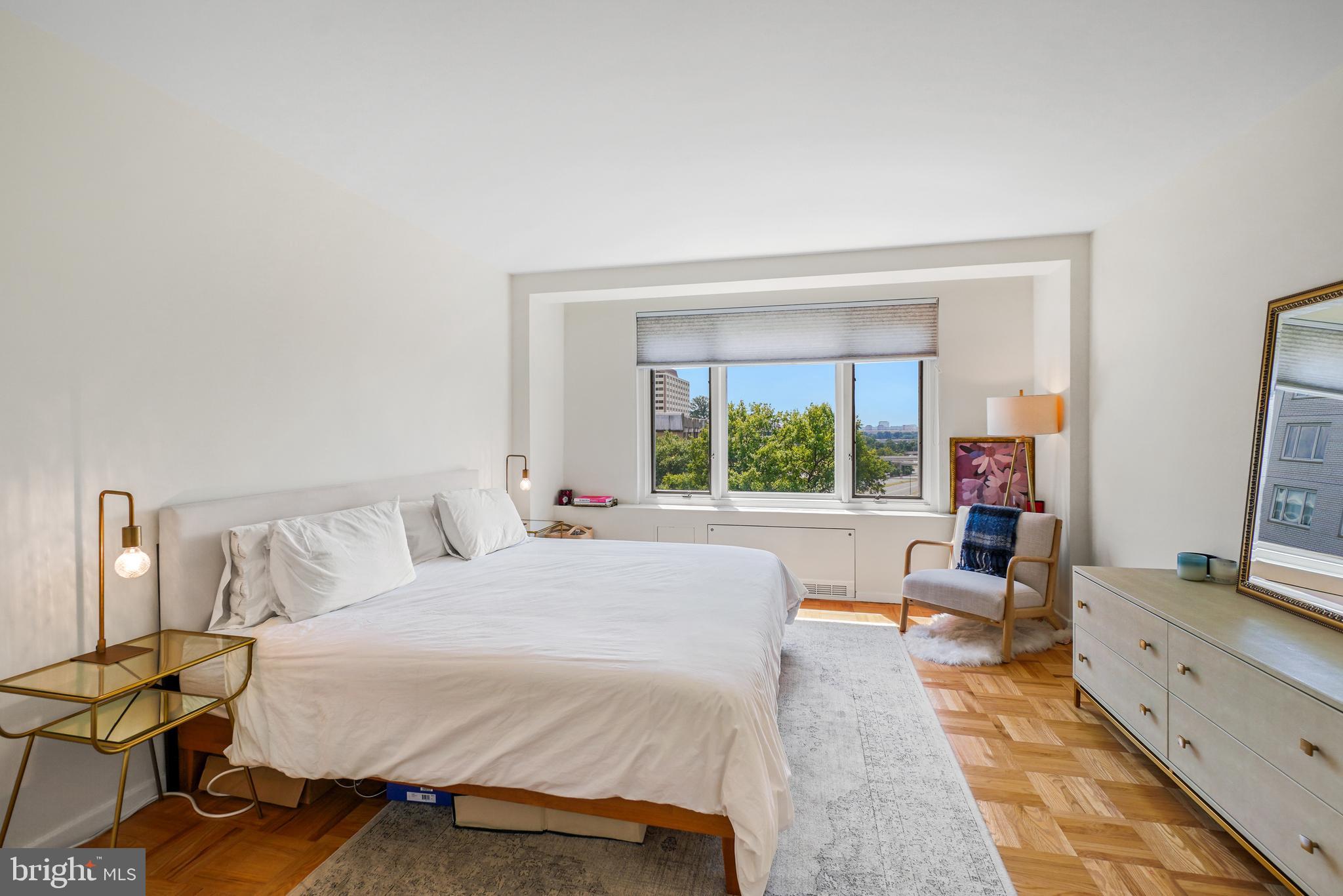 2475 Virginia Avenue Northwest, Unit 728 Washington, DC 20037 - Photo 18 of 32 a bed sitting in a bedroom next to a window