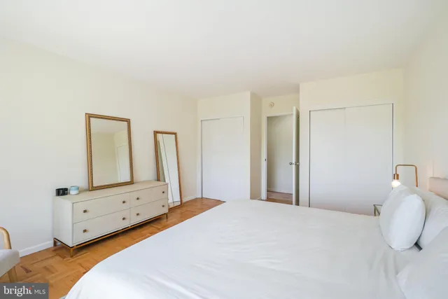 a bedroom with a bed and a mirror