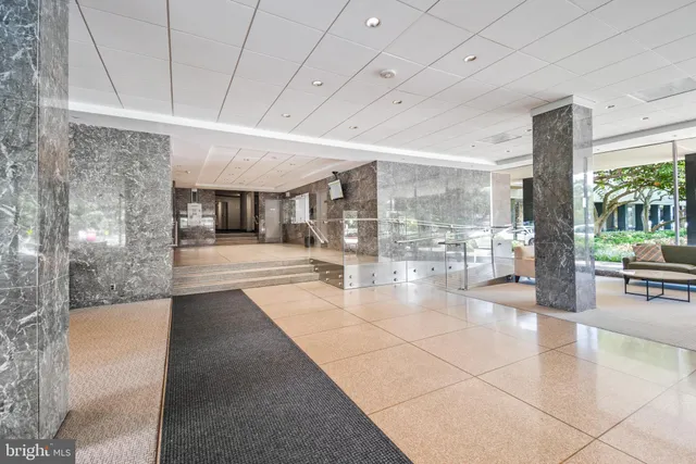 a lobby with entryway and a rug