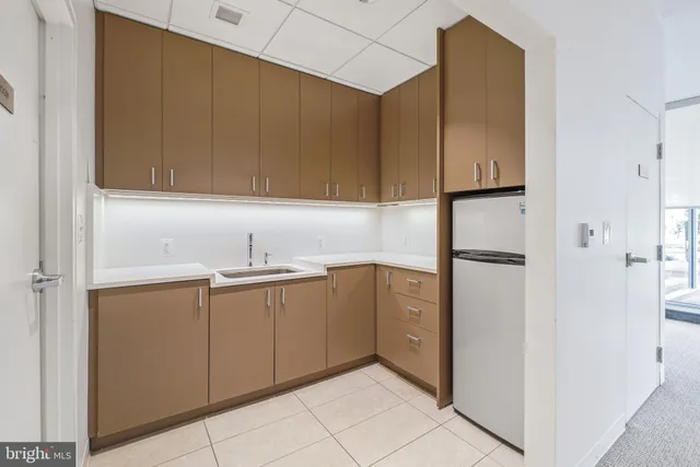 a kitchen with a sink and refrigerator