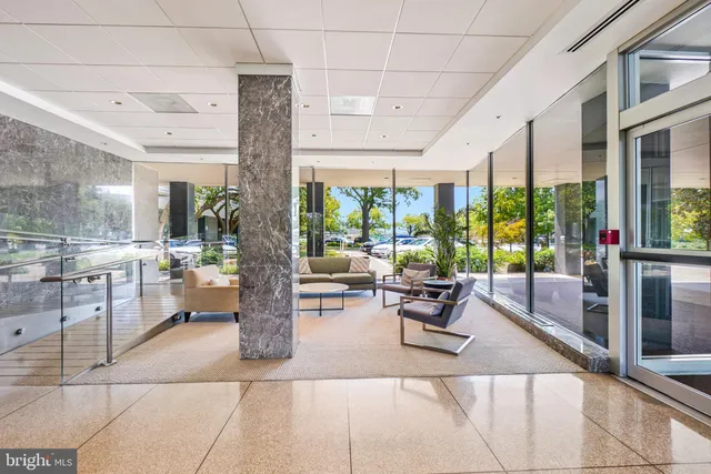 a lobby with furniture and floor to ceiling window