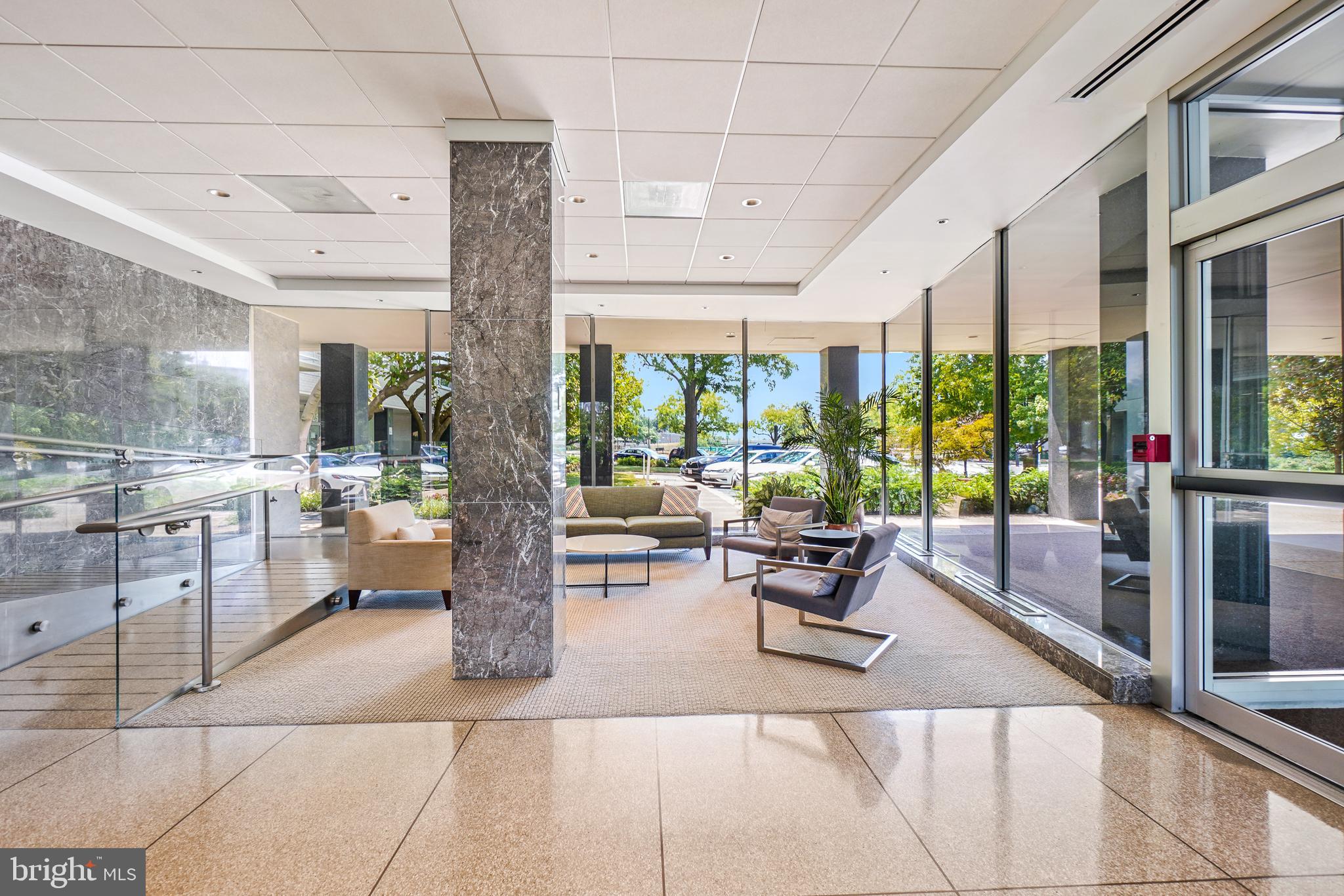 2475 Virginia Avenue Northwest, Unit 728 Washington, DC 20037 - Photo 3 of 32 a lobby with furniture and floor to ceiling window