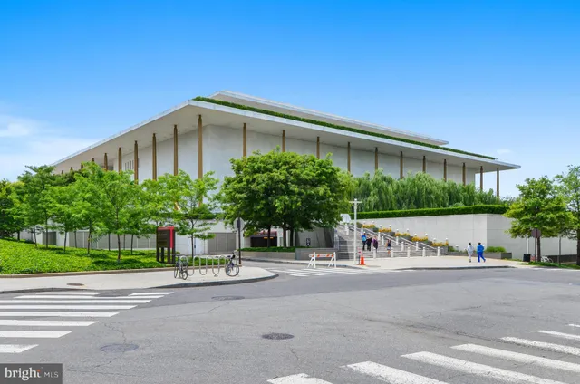 a front view of a house with a garden and plants