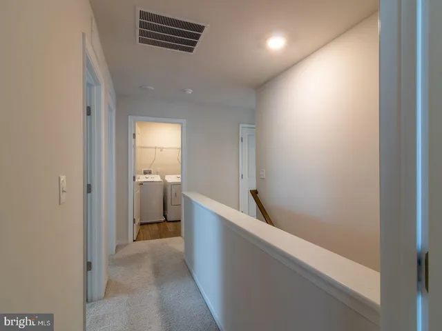 a view of hallway with bathroom