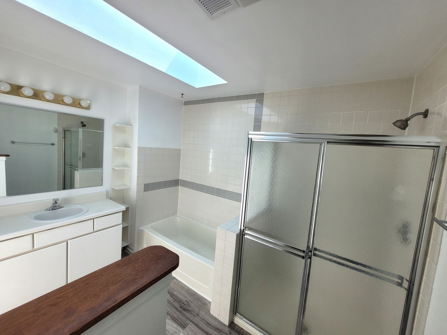 321 Sheffield Drive, Unit 321 Schaumburg, IL 60107 - Photo 12 of 21 a bathroom with a shower sink and mirror