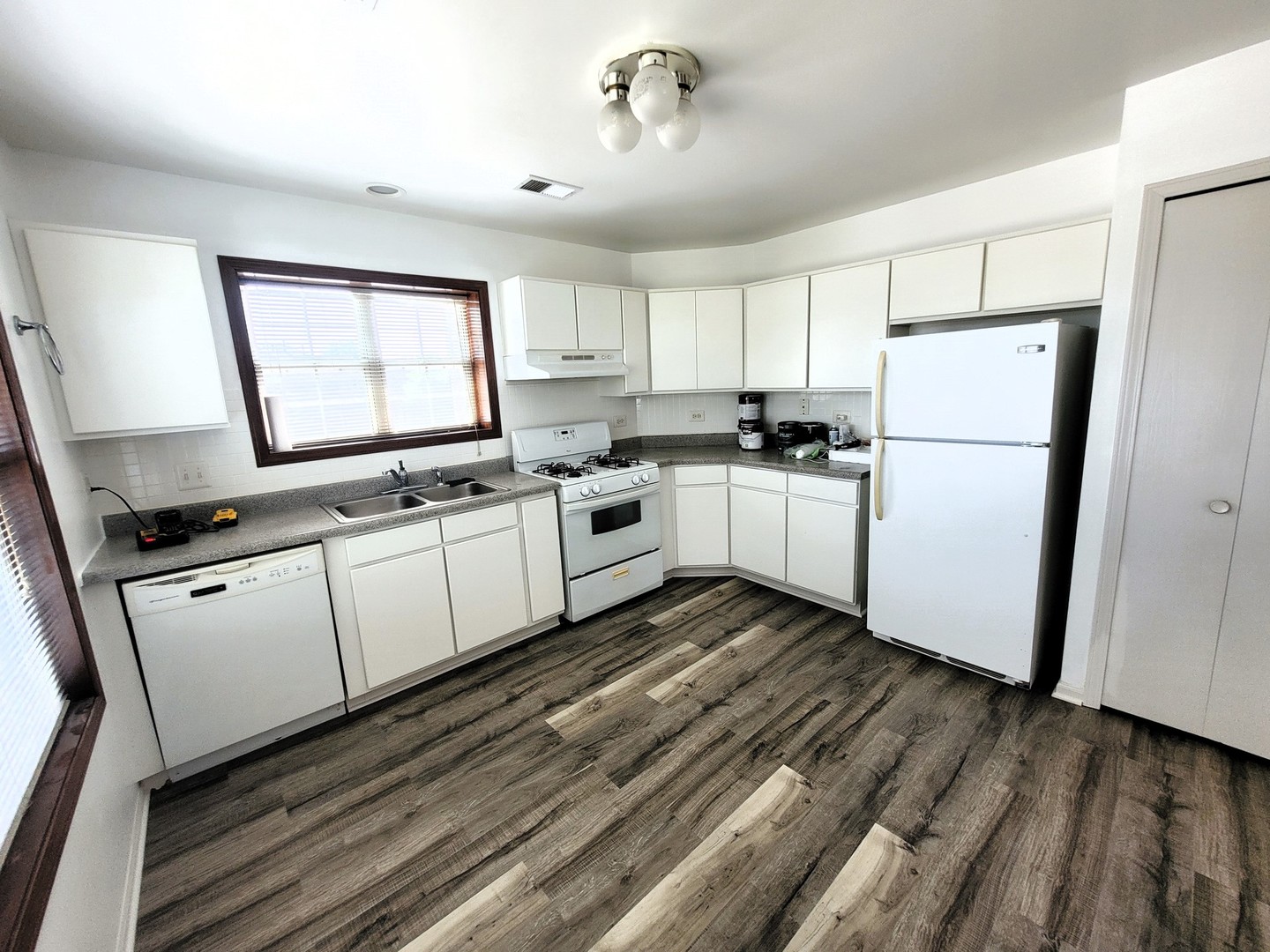 321 Sheffield Drive, Unit 321 Schaumburg, IL 60107 - Photo 4 of 21 a kitchen with white cabinets and white appliances