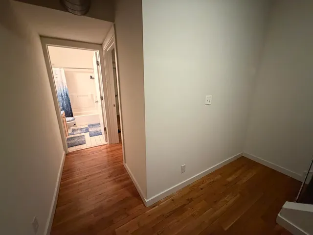 a bathroom with a sink a toilet a mirror and shower