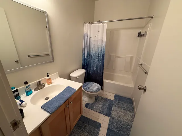 a bedroom with a bed and a mirror