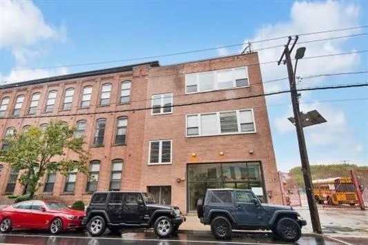 a view of a brick buildings with entryway doors