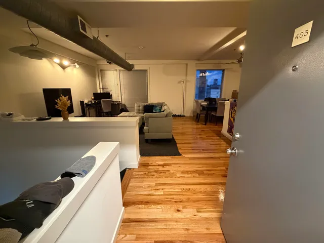 a living room with furniture a flat screen tv and a table