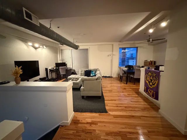 a living room with furniture flat screen tv and a fireplace