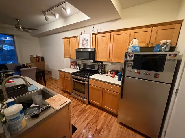 a view of a living room with furniture and wooden floor