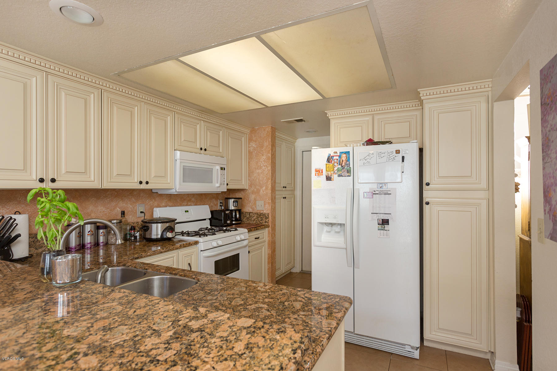 1920 Rory Lane, Unit 3 Simi Valley, CA 93063 - Photo 3 of 10 a kitchen with stainless steel appliances granite countertop a refrigerator and a stove top oven