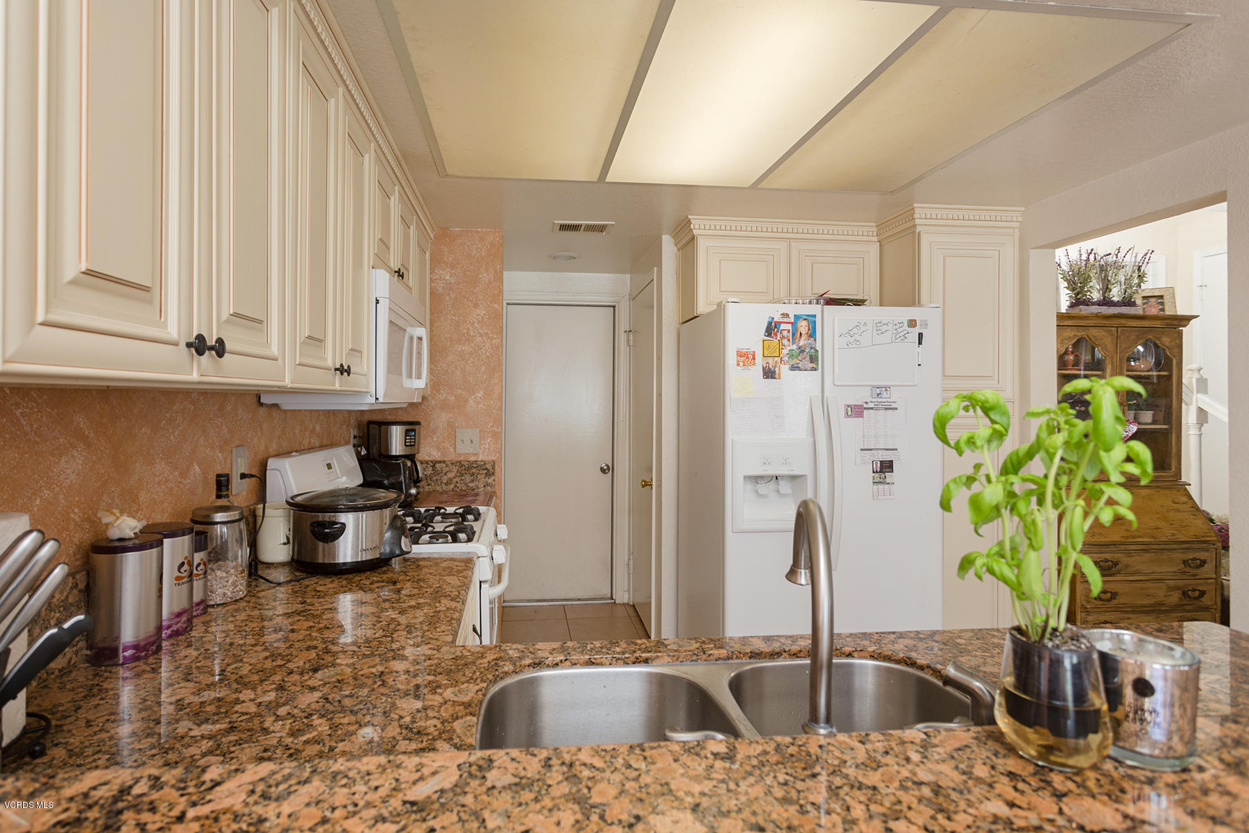 1920 Rory Lane, Unit 3 Simi Valley, CA 93063 - Photo 4 of 10 a kitchen with stainless steel appliances a sink a counter top space cabinets and wooden floor