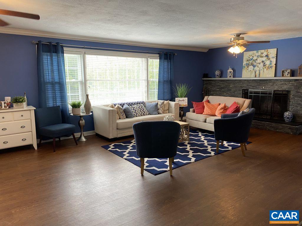 455 Burgoyne Road, Unit 8 Charlottesville, VA 22901 - Photo 12 of 12 a living room with furniture a fireplace and a large window