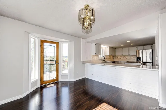 a view of a dining room with furniture window and wooden floor