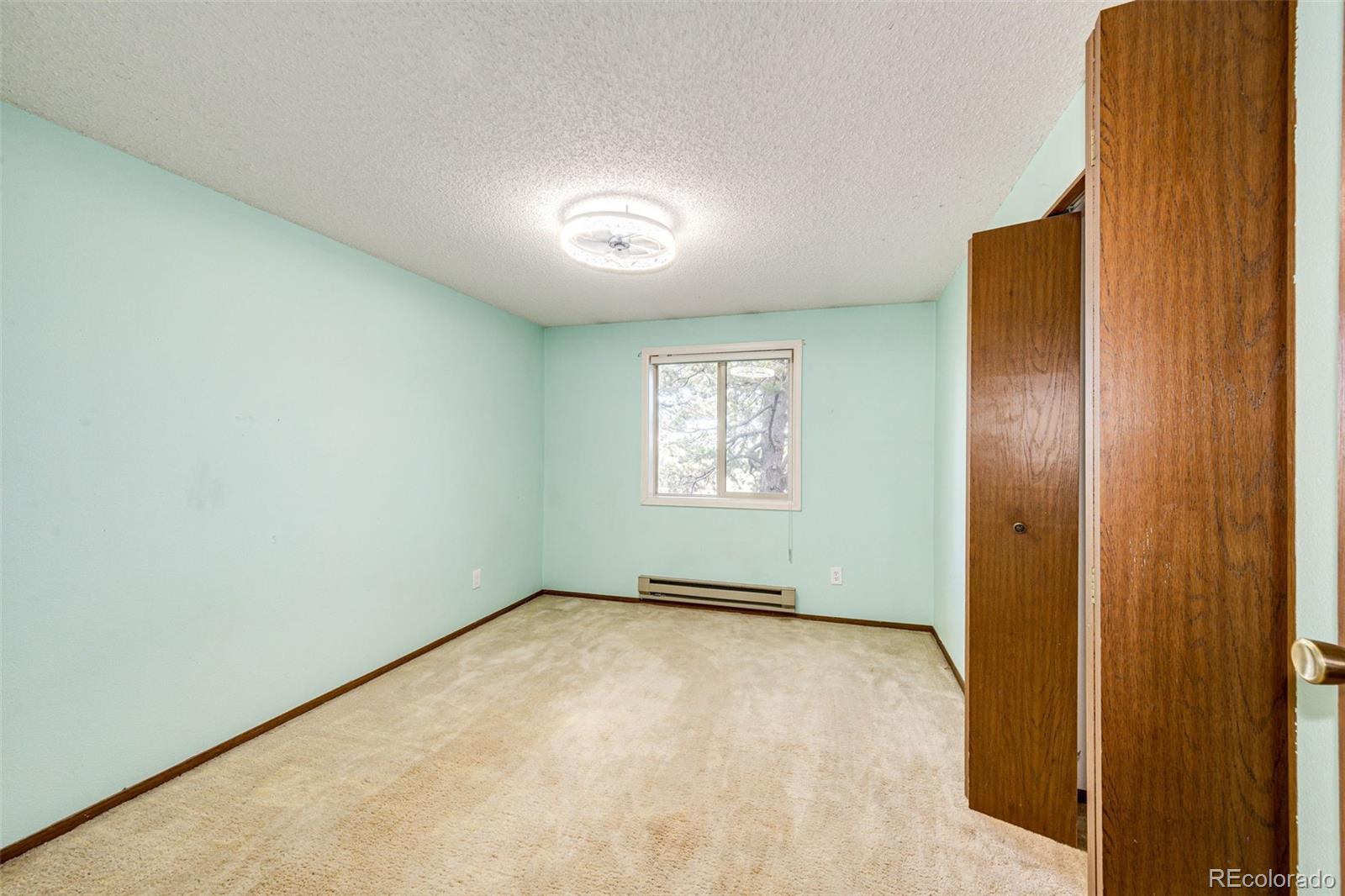 7417 Rafter Road Franktown, CO 80116 - Photo 17 of 37 an empty room with windows
