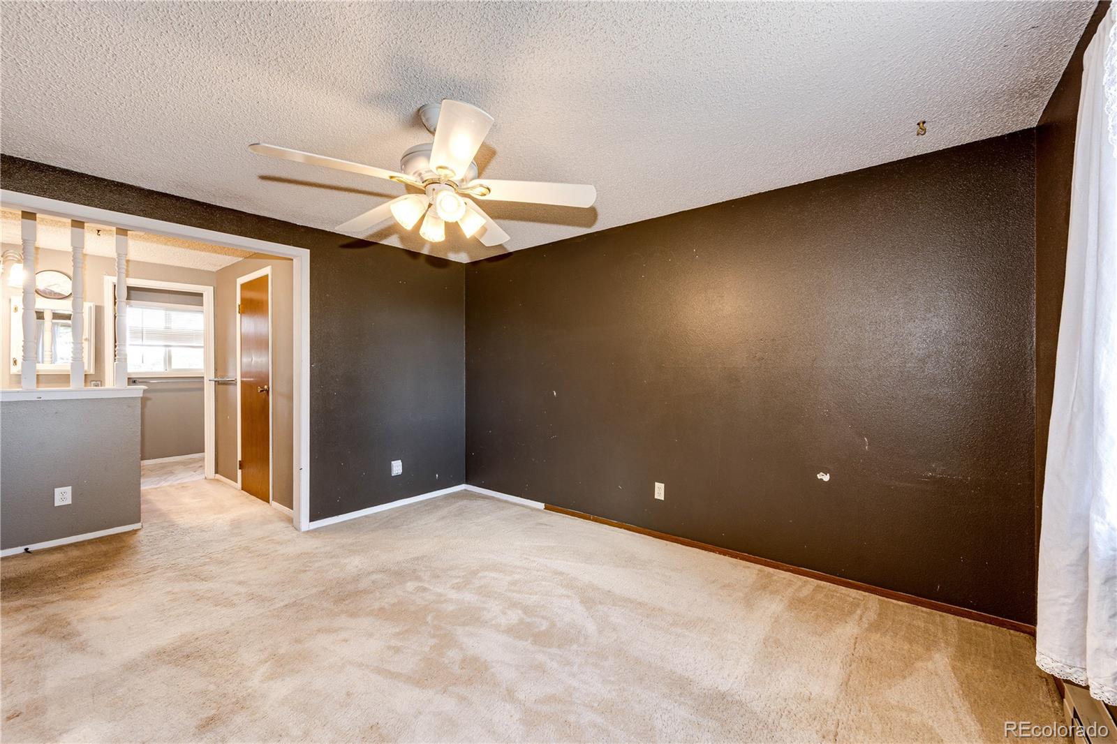 7417 Rafter Road Franktown, CO 80116 - Photo 18 of 37 a view of a livingroom with a chandelier fan and windows