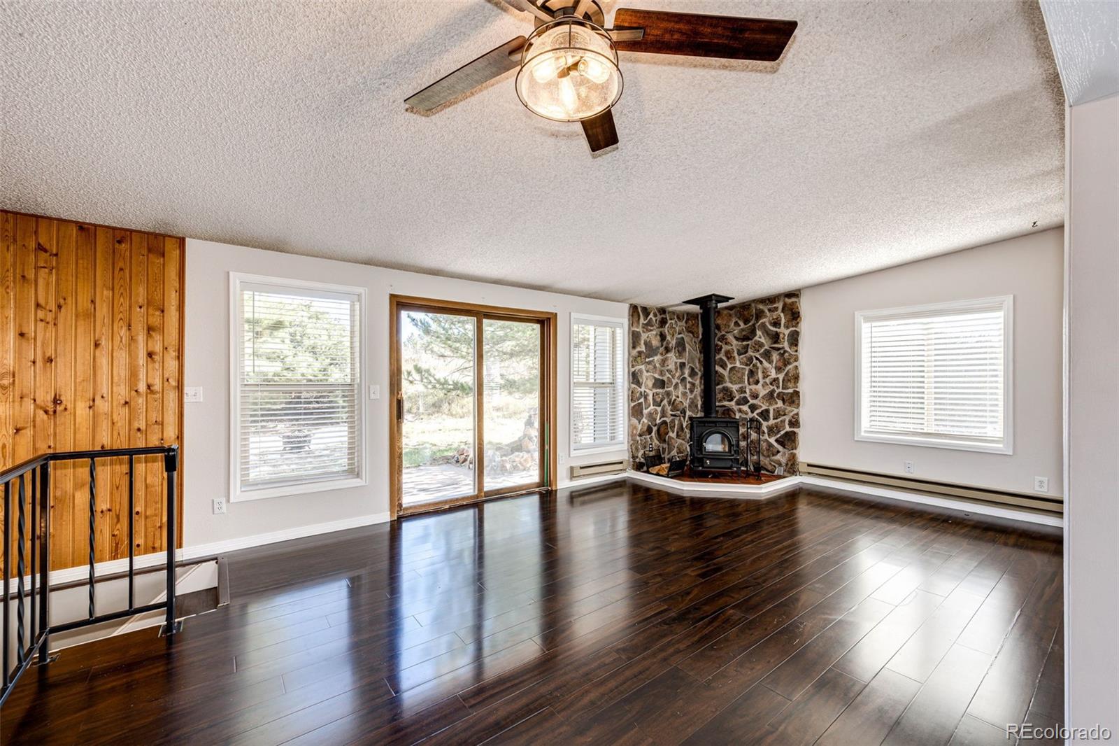 7417 Rafter Road Franktown, CO 80116 - Photo 2 of 37 a view of an empty room with wooden floor and a window