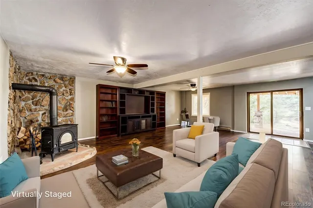 a view of empty room with wooden floor and window