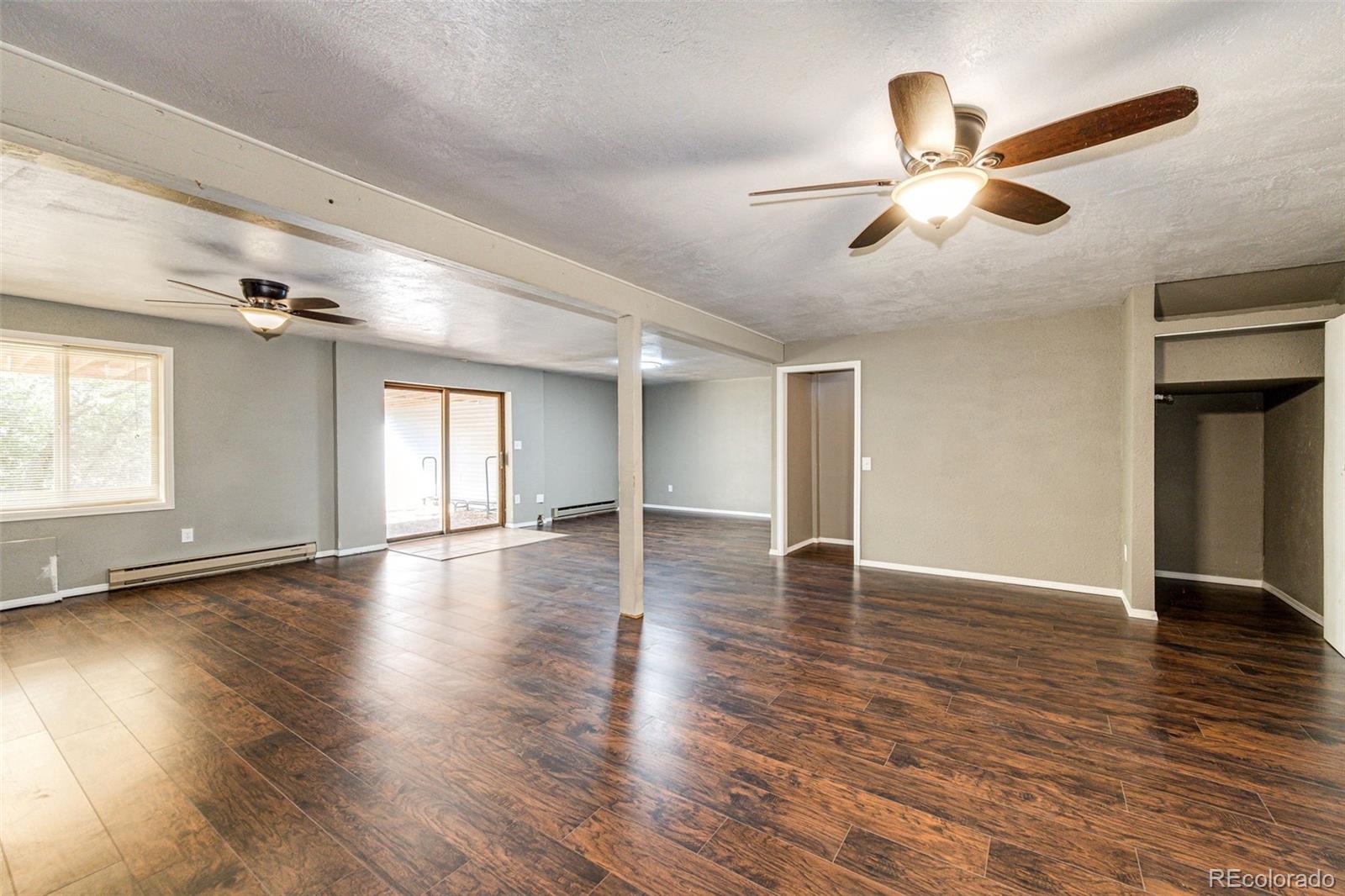 7417 Rafter Road Franktown, CO 80116 - Photo 26 of 37 a view of empty room with wooden floor and window
